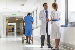 doctors-hospital-corridor-nurse-pushing-wheelchair