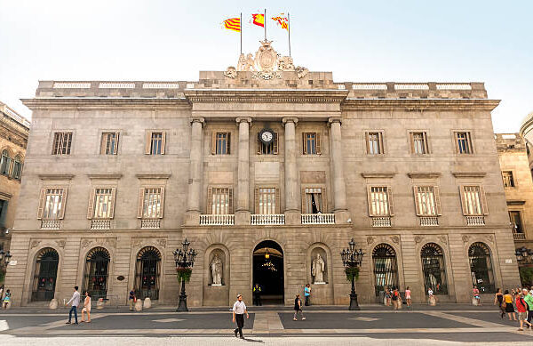 Barcelona, Spain - July 6, 2015: The Palau de la Generalitat is a historic palace in Barcelona, Catalonia, Spain. It houses the offices of the Presidency of the government of Catanonia. People are walking by square.